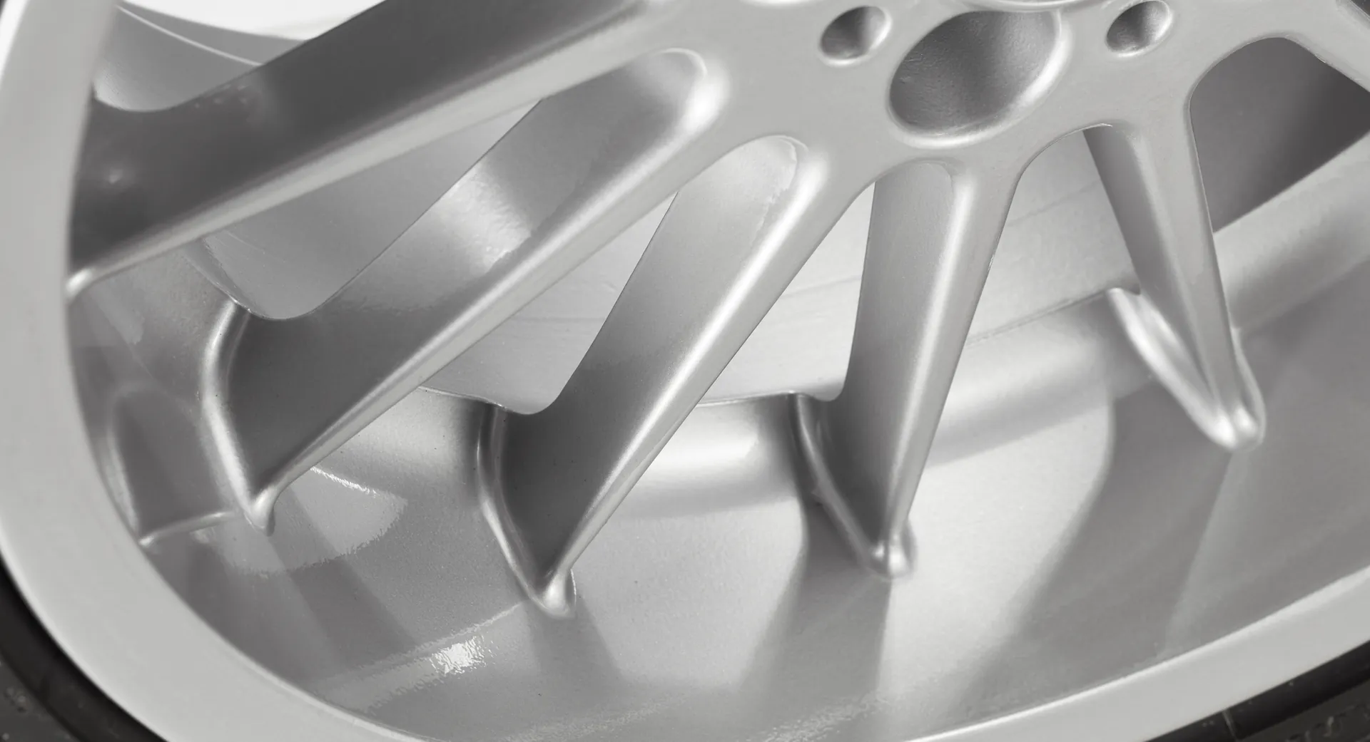 Close-up of a freshly refurbished silver alloy wheel with a flawless painted finish